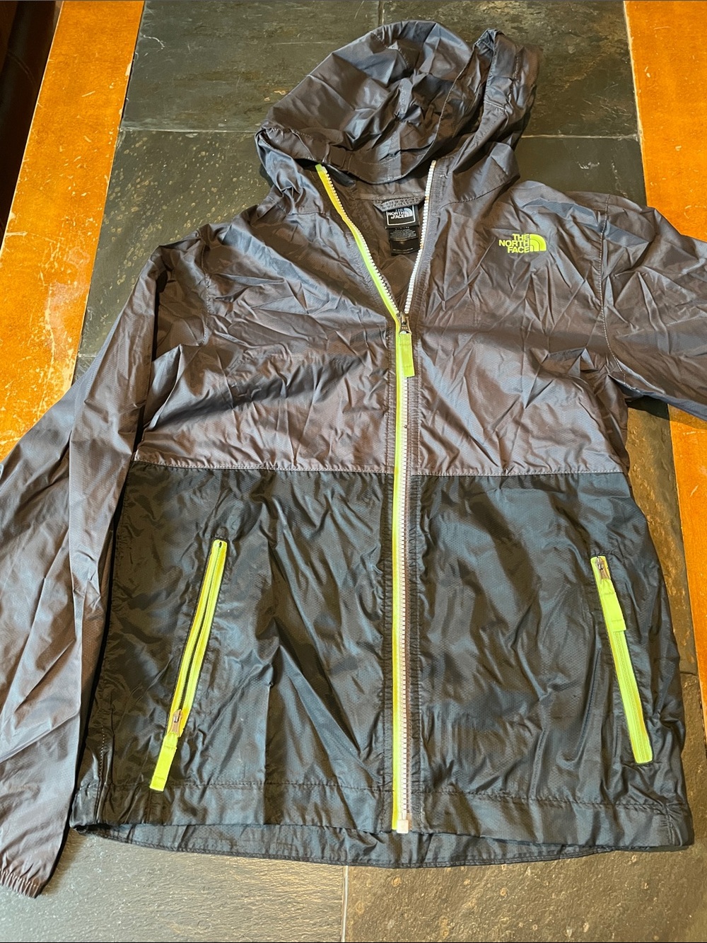 The North Face Kids Two-Tone Black and Charcoal Raincoat with Lime Zippers